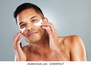 Model, Skincare And Eye Mask For Man In Portrait For Health, Wellness And Cosmetics With Grey Backdrop. Face, Cosmetic And Facial For Beauty, Self Love And Self Care With Studio Background For Care