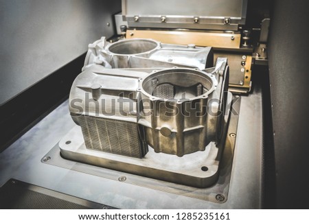 A model with supports created in a laser sintering machine stays in the working chamber. DMLS, SLM, SLS technology. Concept of 4.0 industrial revolution. Progressive modern additive technology.