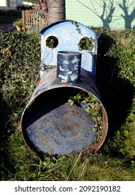 A Model Train Engine Made Out Of An Old Oil Drum, Very Rusty And Neglected, On A Grass Verge In West Wales, UK.