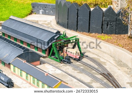 Model train pulling into depot in toy town