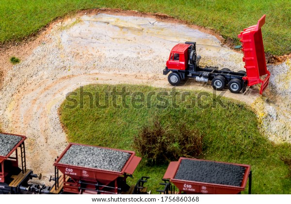 Model\
truck in scale H0 on train layout in stone\
pit
