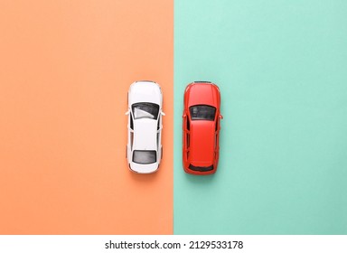 Model Of Two Toy Car On Blue-pink Background. Top View. Flat Lay