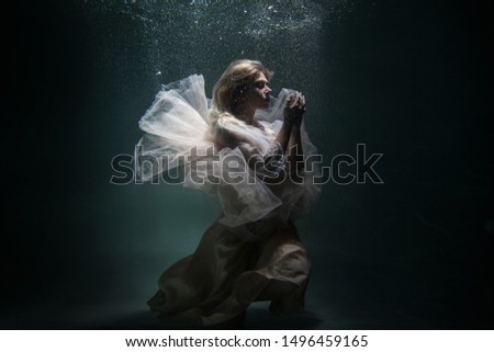 model underwater in a beautiful dress