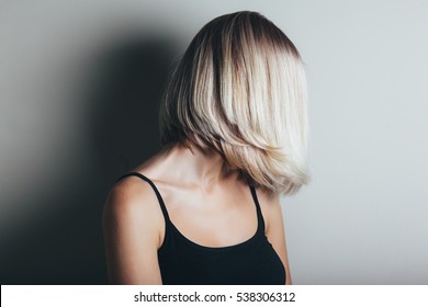 Model With Unrecognizable Face With Blond Shiny Hair. Woman Bob Haircut Styling.