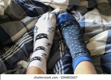 Model Using A Pair Of Mismatched Socks In The Bed