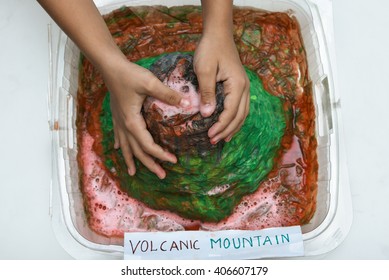 Model Of Volcano, Science Fair Project/ School Science Project, Kids Presenting Their Science Home Project At School. Volcanic Mountain Eruption Molten Lava, Prepared For Education Purpose For Kids