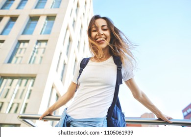 Model Wearing Plain White T-shirt, Boyfriend Jeans, Sneakers And Hipster Sunglasses Posing Against Street, Teen Urban Clothing Style.