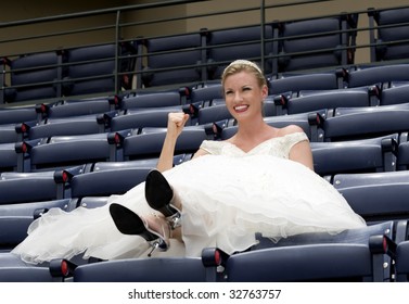 Model Wearing Wedding Gown Cheering In A Baseball Stadium.