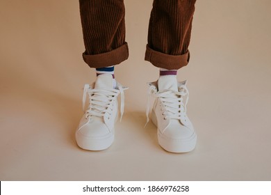 Model Wearing White Sneakers With Untied Shoelaces