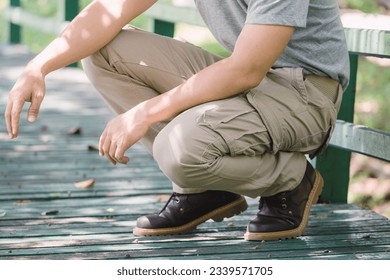 Model wearing yellow brown  color cargo pants or cargo trousers - Shutterstock ID 2339571705