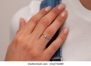 The Model In A White Dress Is Flamboyant Of Silver Ring On Her Finger. Image For Ecommerce, Online Selling, Social Media, Jewelry Sale.