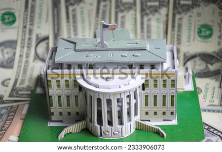 model of a white house against the background of us dollars, a flag is installed on the roof. residence of the President. the capital of country. dollar hegemony in the global financial market