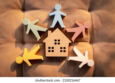 Model of a wooden house and a model of people surround the house.
Concept of happy family, People living and caring for homes, buying, mortgages, and real estate investments. - Powered by Shutterstock