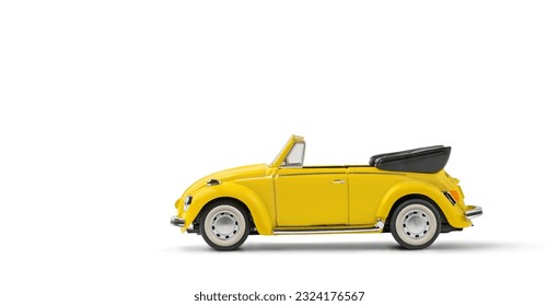 Model of yellow retro toy car cabriolet on a white background. Miniature car side view