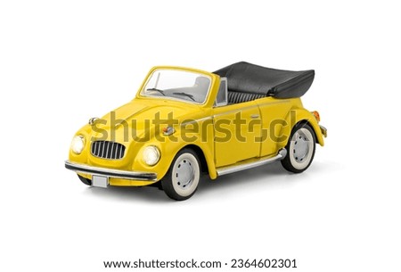 Model of yellow retro toy car cabriolet on a white background.