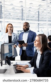 Modeling integrated circuit systems, PC and portrait of multiracial team in RD office. Optimizing microchip hardware manufacturing, computer program and teamworking colleagues in tech laboratory