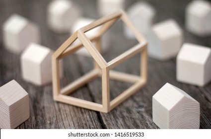 Models Of Miniature Wooden Houses With A Big House In The Center