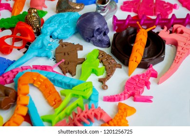 Models printed by 3d printer. Bright colorful objects printed on a 3d printer on a table close-up. Fused deposition modeling, FDM. Concept modern progressive additive technology for 3d printing.