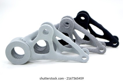 Models printed on 3D printer isolated on white background. Objects details printed on 3D printer from plastic close-up. Prototypes of shapes made by 3d printer. Concept new modern printing technology