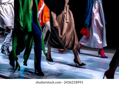 Models in trendy fashion outfits at the fashion show finale. Women's modern stylish clothing