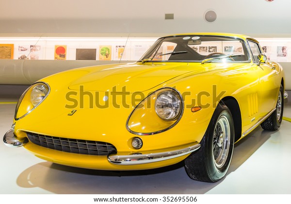 MODENA, ITALY - APRIL 2015:
Museum Enzo Ferrari Modena. Yellow Ferrari 275 GTB 4 1966 with The
Cavallino Rampante (Ferrary horse), symbol of Ferrari on hood.
Front view.