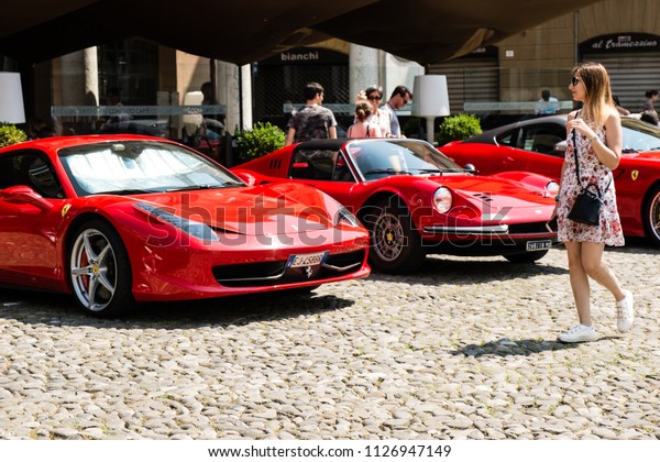 MODENA, ITALY - June, 2018. Girl walks in the square\
between Ferrari cars