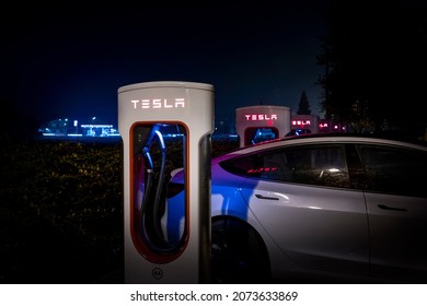Modena, Italy - November 12, 2020: Tesla supercharger station at night.