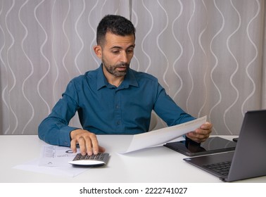 Modena Italy - October 31 2022: A Man Who Looks At The High Gas Bill To Pay