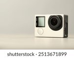 Modern action camera on light background, closeup. Space for text