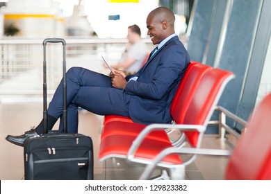 modern african businessman using tablet computer at airport