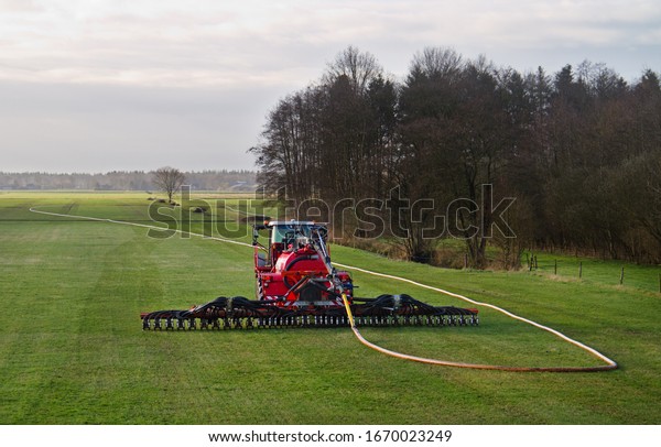 Modern agriculture: injection of liquid\
manure in grass land using a drag hose\
applicator