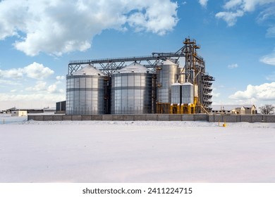 modern agro-processing plant for processing and silos for drying cleaning and storage of agricultural products, flour, cereals and grain in snow of winter field