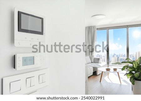Modern air conditioning control, intercom display, switches on white wall in cozy light apartment, free space