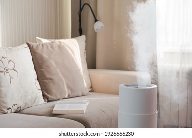 Modern air humidifier, aroma oil diffuser at home. Improving the comfort of living in a house, Improving the well-being. Ultrasonic steam technology.