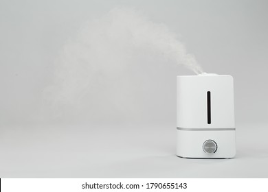Modern air humidifier on light grey background. Space for text
