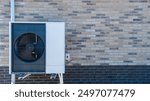 A modern air source heat pump is mounted on a brick wall, efficiently providing heating and cooling, harnessing outdoor air for comfort. warmte pomp translation air source heat pump