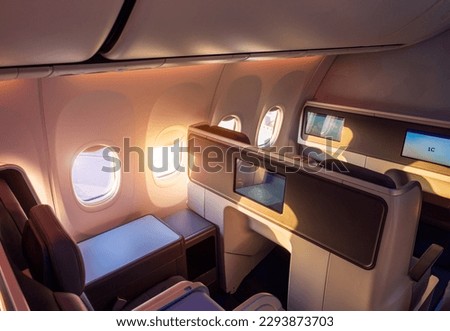 Modern airplane interiors, luxury first class and business class seats with entertainment area.
