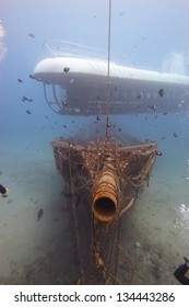 Modern And Ancient: A Submarine Hovers Above An Old Ship Wreck.