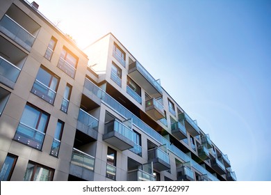 Modern apartment building exterior concept. Sunshine sun flare.