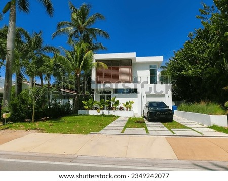 Modern apartment building or house with palm trees at Miami - view from road