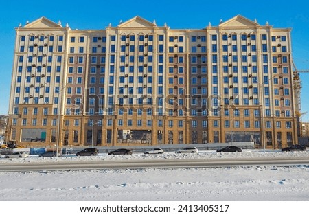 Modern apartment building. New residential area. Contemporary architecture. Bright. Blue Sky. Winter. Parking. Ust-Kamenogorsk (kazakhstan)