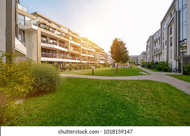 Modern apartment buildings in a green residential area in the city - Shutterstock ID 1018159147