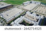 Modern apartment complex central courtyard and flat roof commercial HVAC units packages, surrounded by multilevel parking garages, office building, commercial property in Cypress Waters, Dallas. USA