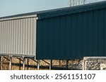 Modern architectural boatshed reflecting serene waters and evening light.