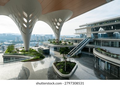 Modern Architectural Complex with Curved Canopy and Green Landscaping