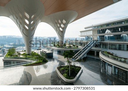 Modern Architectural Complex with Curved Canopy and Green Landscaping