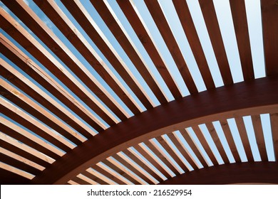 Modern architectural construction of wooden slats with half-round, openwork design  - Powered by Shutterstock