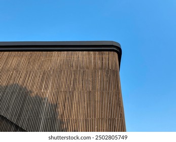 Modern architectural design featuring a curved facade with vertical wooden - Powered by Shutterstock