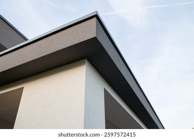 Modern architectural design featuring sharp angles and clean lines against a clear sky background empty space 
