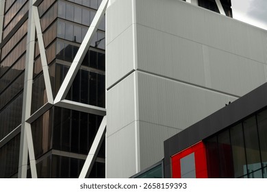 Modern architectural design showcasing intersecting lines and materials in an urban environment during cloudy daylight hours